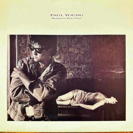 BETWEEN TWO FIRES - PAUL YOUNG